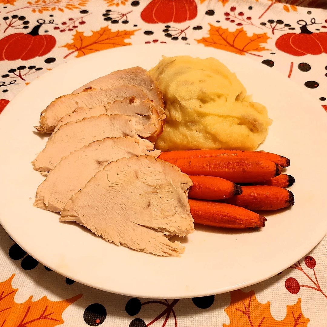 Thanksgiving meal with turkey, carrots, and mashed potatoes