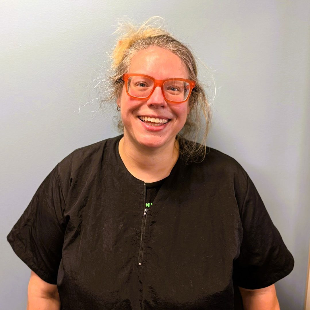 smiling blonde woman wearing red glasses